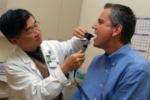 Dong Shin, MD, examines a patient at Emory